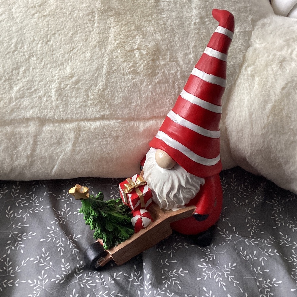 Gnome pushing wheelbarrow